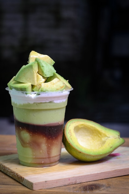 Premium Photo | Milkshake with avocado pieces, in plastic cup ...