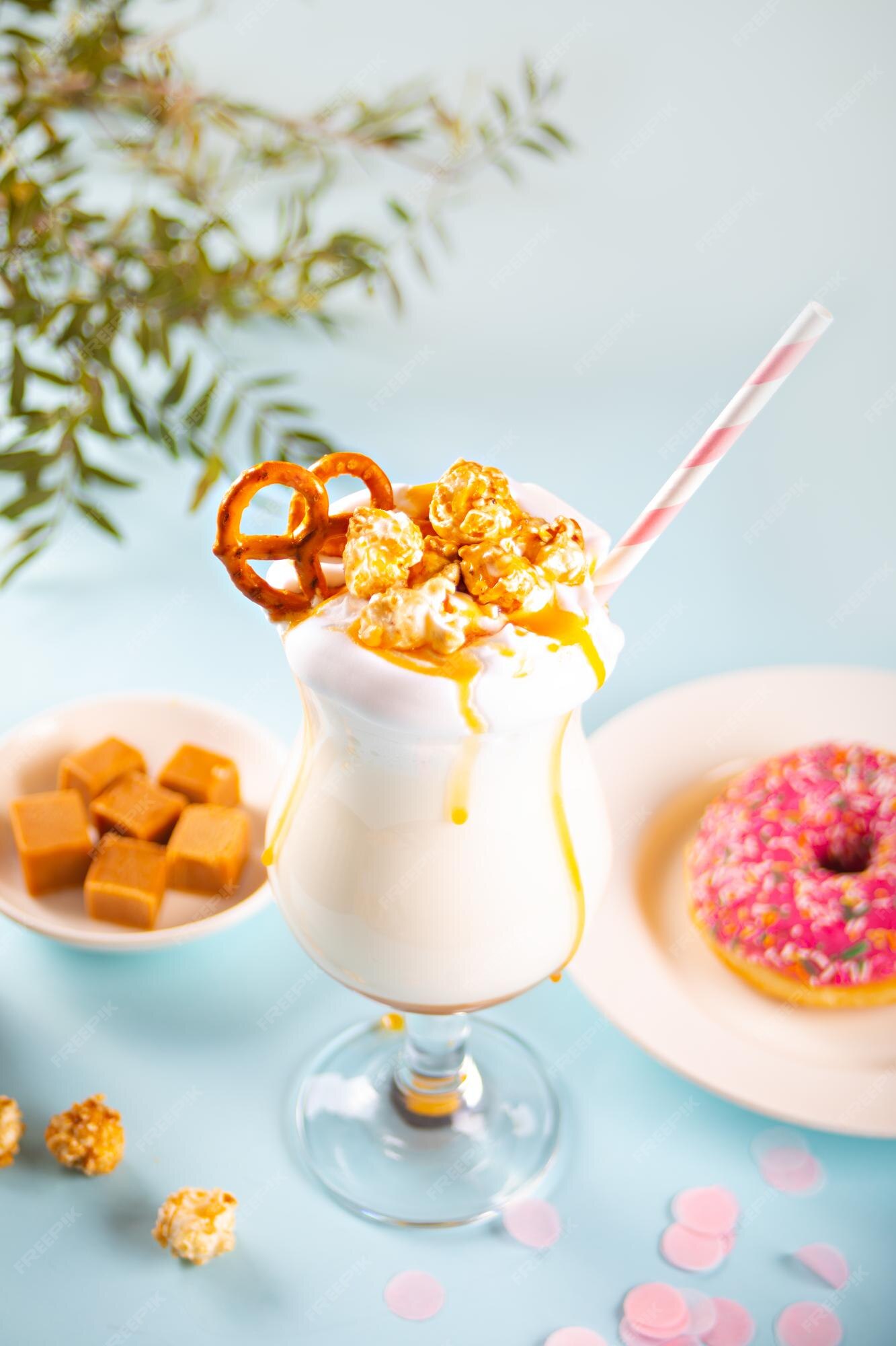 Premium Photo | Milkshake with caramel syrup, popcorn and brezel waffles