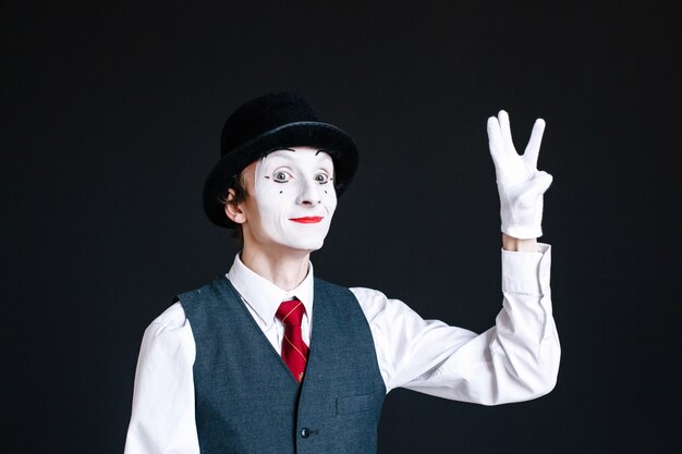 Free Photo | Mime shows sign of victory with his fingers