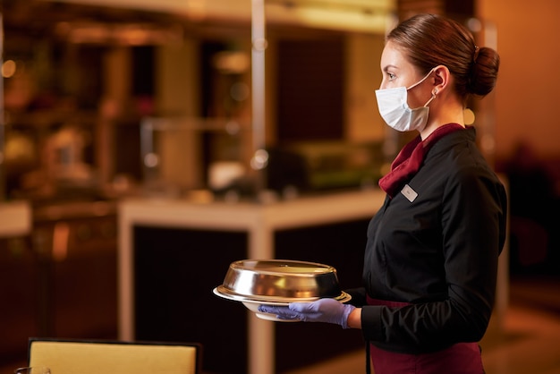Premium Photo Mindful Waitress Wearing Face Mask While Serving Food