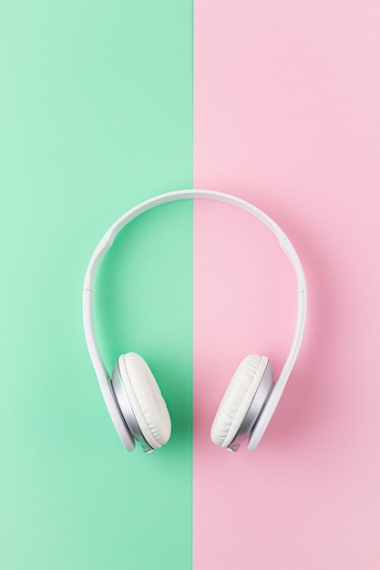 Minimal Flat Lay With Wireless Headphones Over Pink And Light Mint