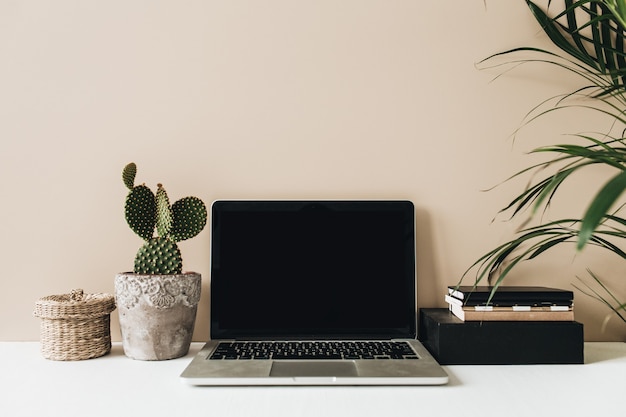 Premium Photo | Minimalist home office desk workspace with laptop, cactus and palm on beige