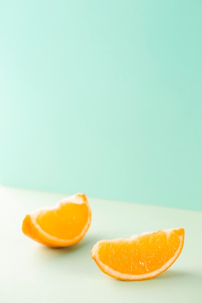 Free Photo | Minimalist slices of orange on blue background