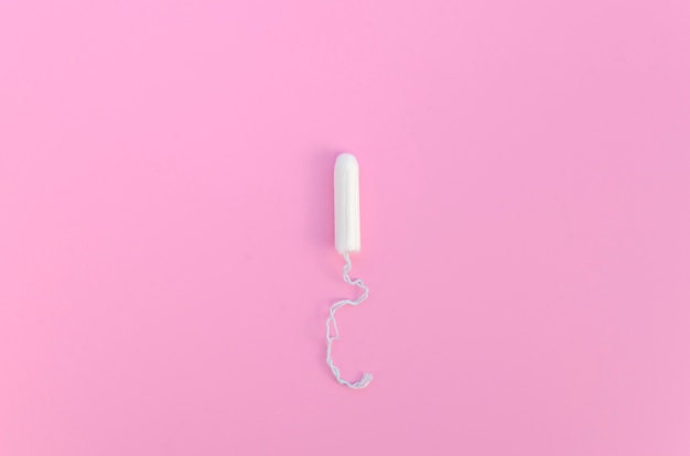 Free Photo | Minimalist tampon on pink background top view