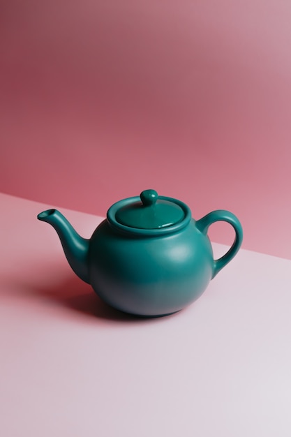 Premium Photo | A minimalistic blue teapot over a pastel pink