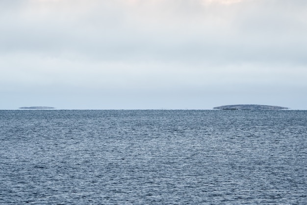 Premium Photo Mirage On The White Sea Islands Hover Above The Water On The Horizon