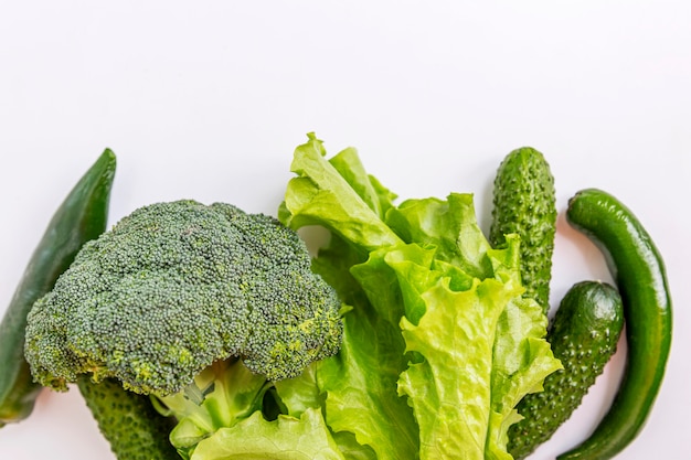 Premium Photo Mix Of Green Vegetables On A White Background Broccoli Lettuce Cucumbers And Hot Peppers Top View Space For Text Healthy Eating And Vegetarianism