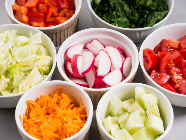 Mix Of Vegetable Bowls For Salad Or Snacks On Gray Diet Detox Concept Premium Photo