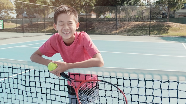 Premium Photo Mixed Asian Preteen Tween Boy Holding Tennis Ball And Racket Tween Sport Kid Active Lifestyle