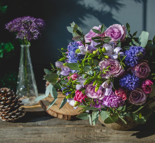 Mixed flower bouquet on a wooden table Free Photo
