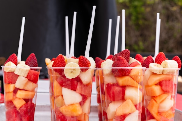 Download Premium Photo Mixed Fruit Salad Arranged In Plastic Cups On A Market Stall