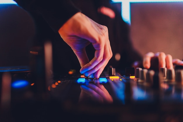 The mixer. remote for sound recording. sound engineer at work in the studio. sound amplifier mixing console equalizer. record songs and vocals. mixing tracks. audio equipment. work with musicians. dj. Premium Photo