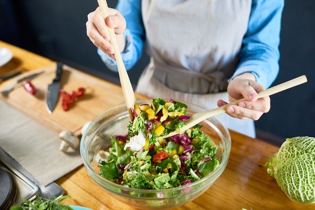 Premium Photo | Mixing vegetarian salad