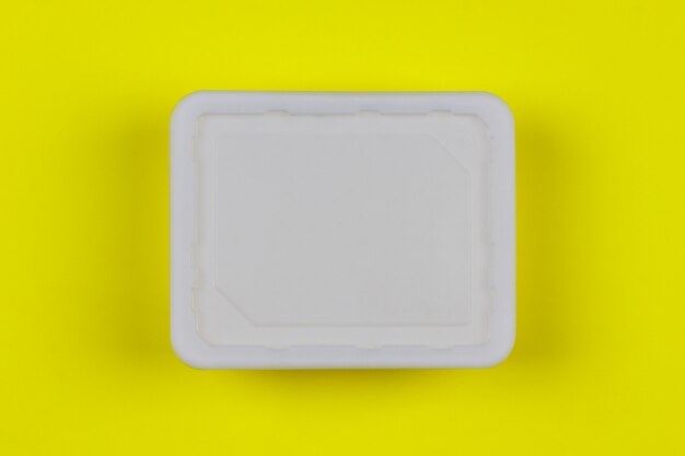 Download Mock-up white plastic box on yellow background top view ...