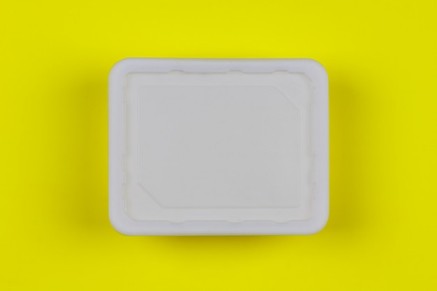 Download Mock-up white plastic box on yellow background top view ...