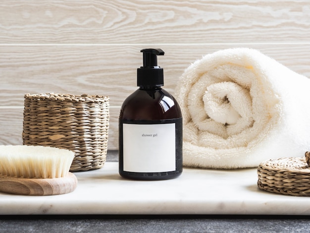  Mockup for bathing products in the bathroom, spa shampoo, shower gel, liquid soap with a towel besi
