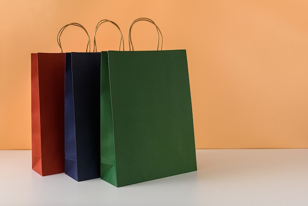 Download Premium Photo | Mockup of blank craft package or colorful paper shopping bag with handles