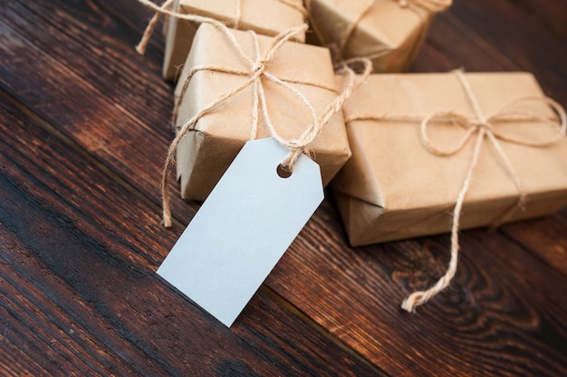 Download Mockup boxes for gifts of kraft paper and gift tags on a wooden surface | Premium Photo
