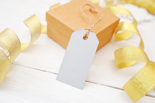 Premium Photo | Mockup christmas gift with blank tag on white wooden