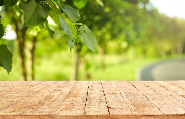 Download Mockup. empty wooden deck table with foliage bokeh ...