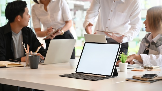 Download Premium Photo | Mockup tablet computer on meeting room with people meeting, empty screen tablet.