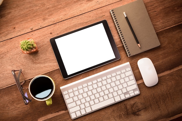 Download Mockup tablet similar to ipad style on wood desk white display.keyboard and office stuff ...