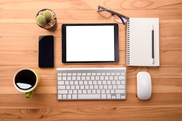 Download Mockup tablet similar to ipad style on wood desk white display.keyboard and office stuff ...