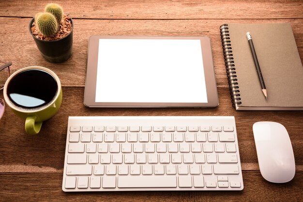 Download Mockup tablet similar to ipad style on wood desk white display.keyboard and office stuff ...