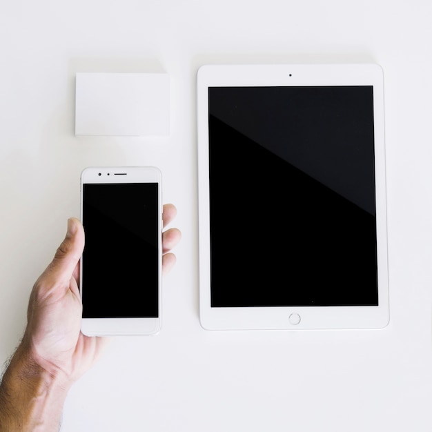 Download Mockup with hand holding smartphone and tablet Photo | Free Download