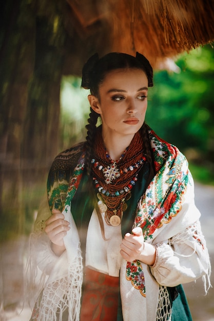 Model in a ukrainian dress poses in the park Photo | Free Download