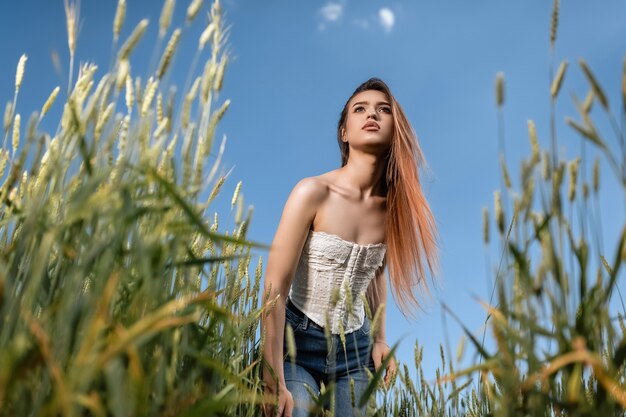Premium Photo | Model in a wheat field from the bottom perspective