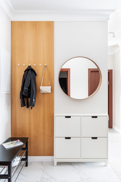Premium Photo Modern Fresh White Hallway Interior Entrance Door Wooden Hanger With Hanging Clothes And A Lady S Purse There Are Shoe Cabinet Near The Door And Round Mirror On The Wall
