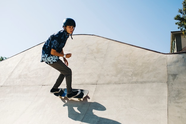 Premium Photo | Modern guy posing during skateboarding