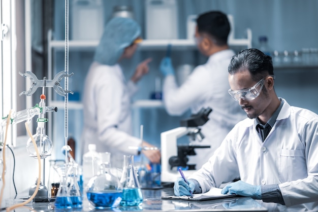 In a modern laboratory scientists team conduct experiments, consisting of glassware  test tubes and microscopes Premium Photo