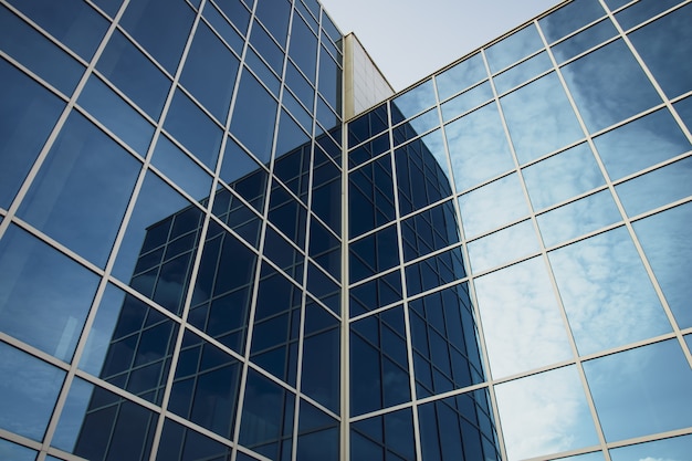 Premium Photo | Modern office building with glass windows and blue sky ...