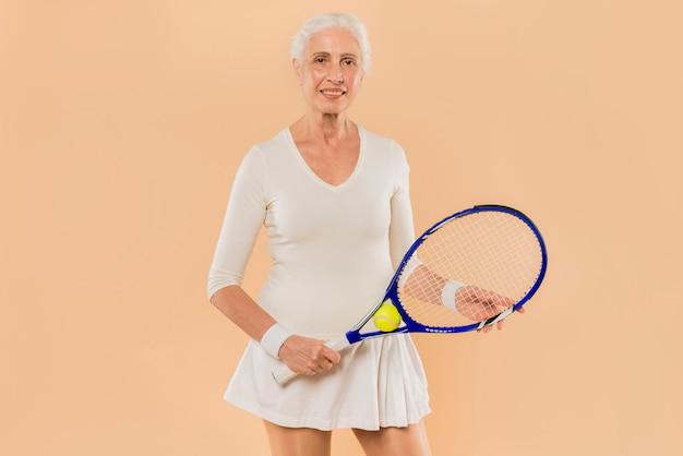 Modern senior woman playing tennis Free Photo