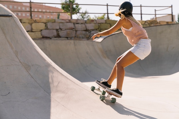 Free Photo | Modern urban girl skating in half pipe