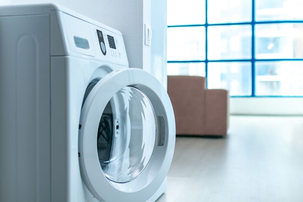 Premium Photo | Modern washing machine in room in apartment. doing ...