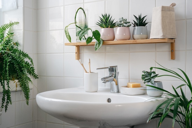  Modern white bathroom with bamboo shelf and many green plants. home comfort zone. wellness and yero