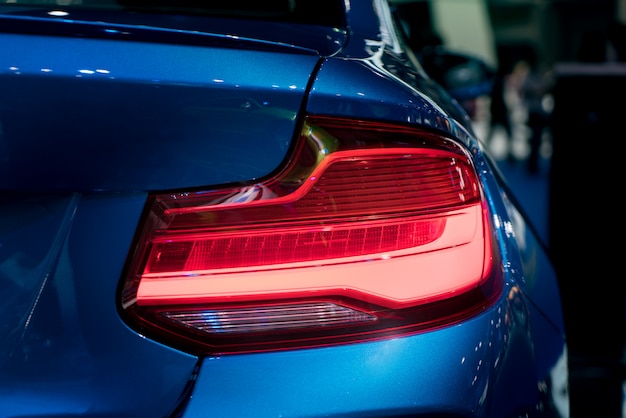 Premium Photo | Modren blue car with red light on the road at night.