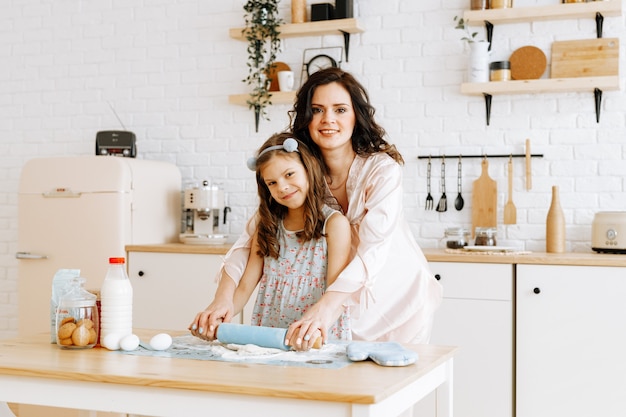 Premium Photo Mom And Daughter Cook Together In The Kitchen 