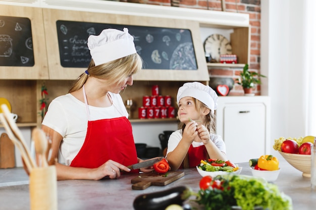 Free Photo | Mom and daughter have fun on the kitchen cooking different