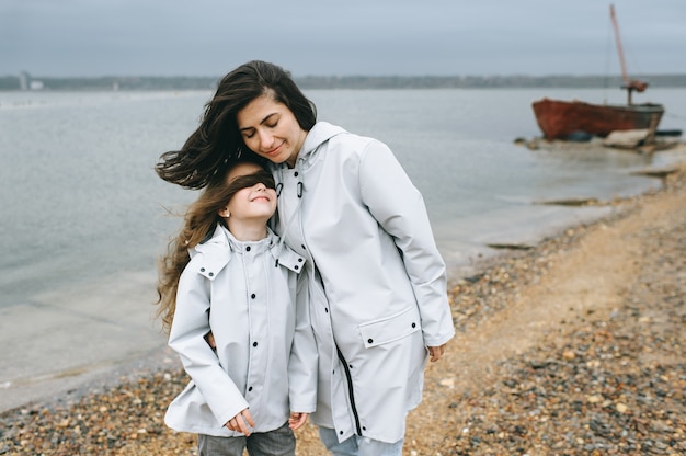 Premium Photo Mom And Dauther Have A Fun On A Boat Background Near The Lake