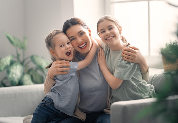 Premium Photo | Mom and her daughters children girls are playing ...