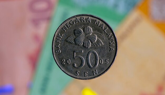 Premium Photo  Money, 50 sen coins on blurred background of 