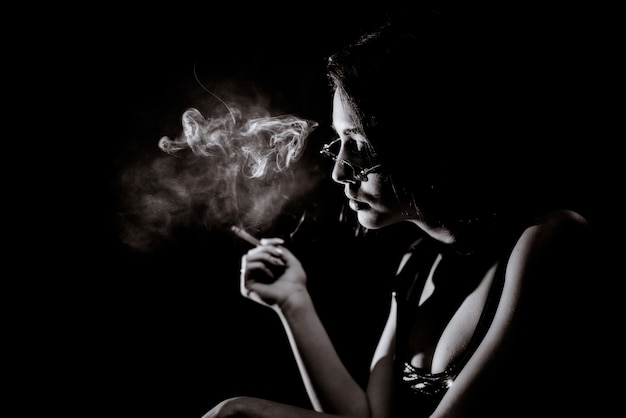 Free Photo | Monochrome portrait of young girl who is smoking with big  decollete and in eyeglasses