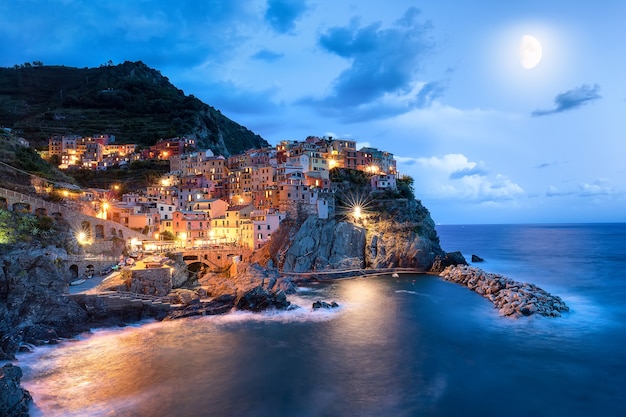 Premium Photo | Moon and manarola village at night, cinque terre, italy ...