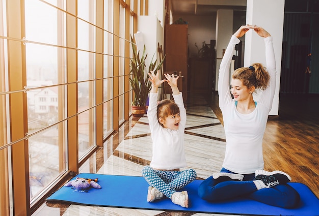 Mother and daughter doing yoga Free Photo