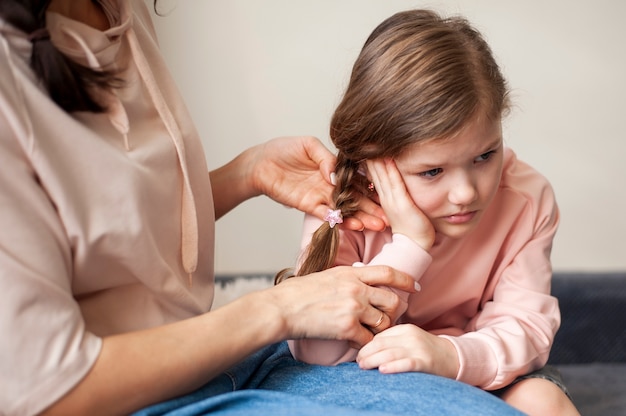 Free Photo | Mother cutting her young girls hair