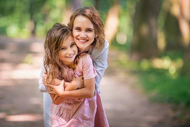 Premium Photo | Mother and daughter are hugging in the park. happy ...